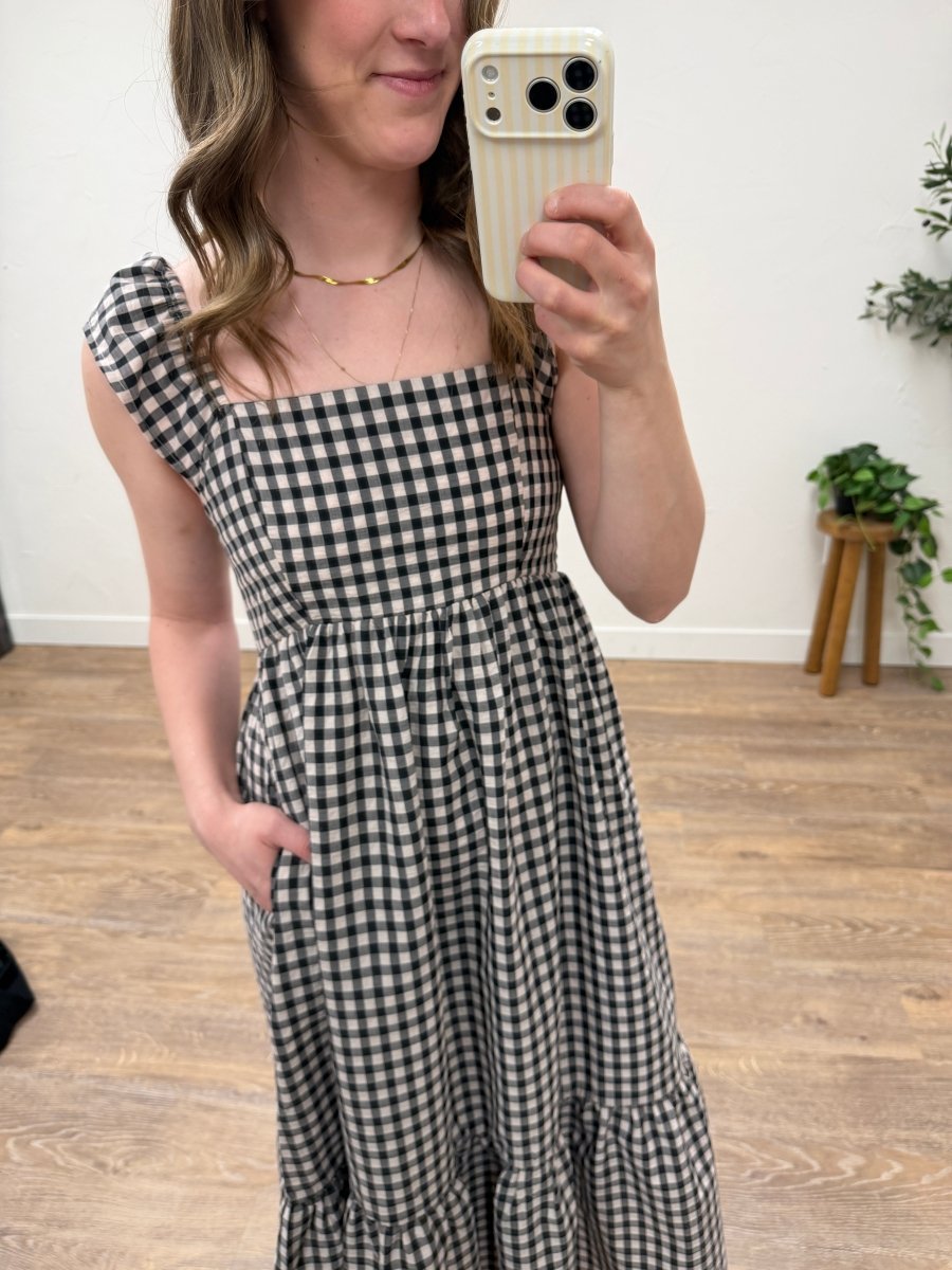 Close up of gingham pattern and ruffle detail on blush and black dress — Three:Twelve Boutique