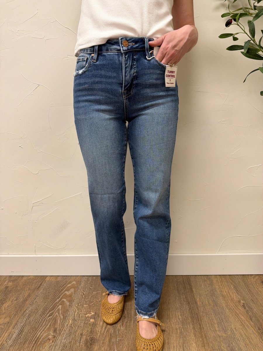 Lifestyle shot of model wearing jeans styled with casual top and sneakers — Three:Twelve Boutique