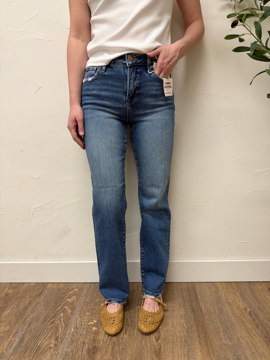 Lifestyle shot of model wearing jeans styled with casual top and sneakers — Three:Twelve Boutique