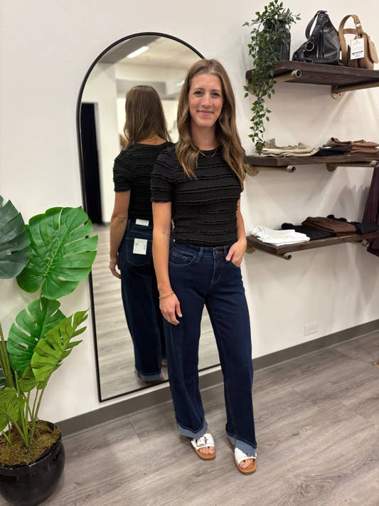 Lifestyle shot of model wearing wide leg jeans styled with casual top — Three:Twelve Boutique