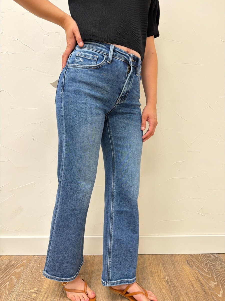 Lifestyle shot of model wearing wide leg denim styled with a casual top — Three:Twelve Boutique