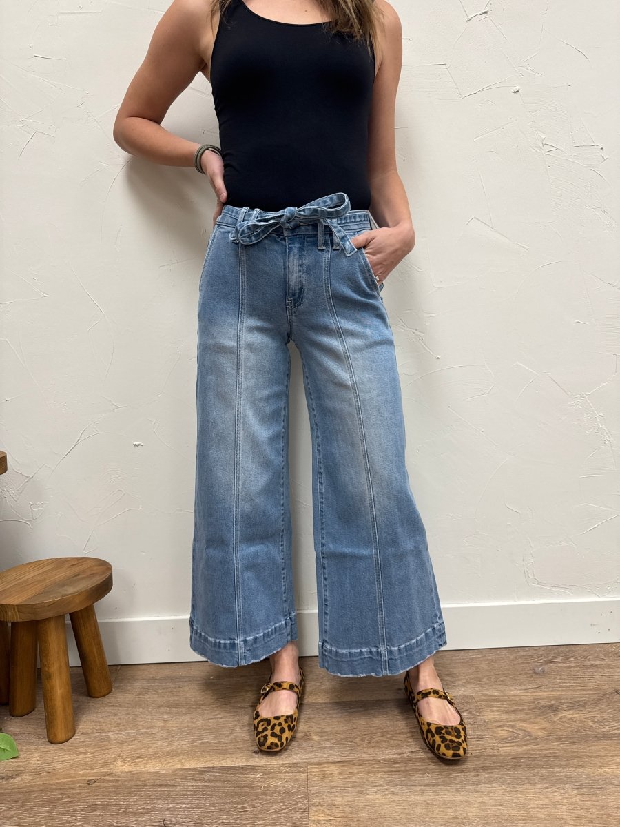 Lifestyle shot of model wearing crop palazzo pants styled with top — Three:Twelve Boutique