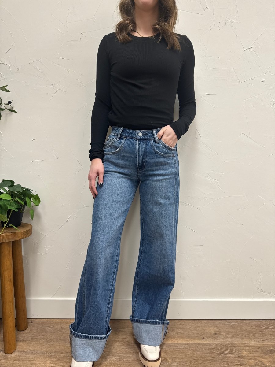 Lifestyle shot of model wearing baggy cuffed jeans styled with casual top — Three:Twelve Boutique