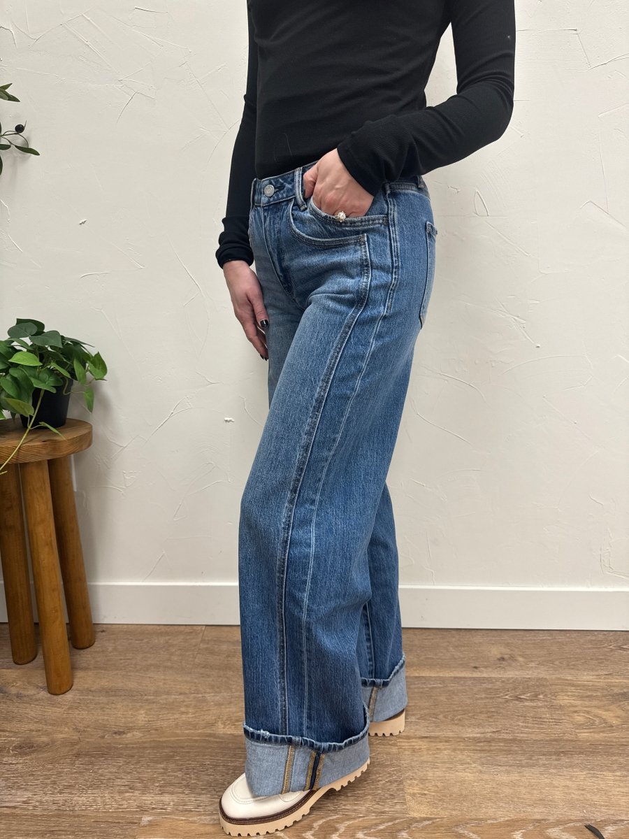 Side view of high rise wide leg jeans showing relaxed silhouette and cuff detail — Three:Twelve Boutique