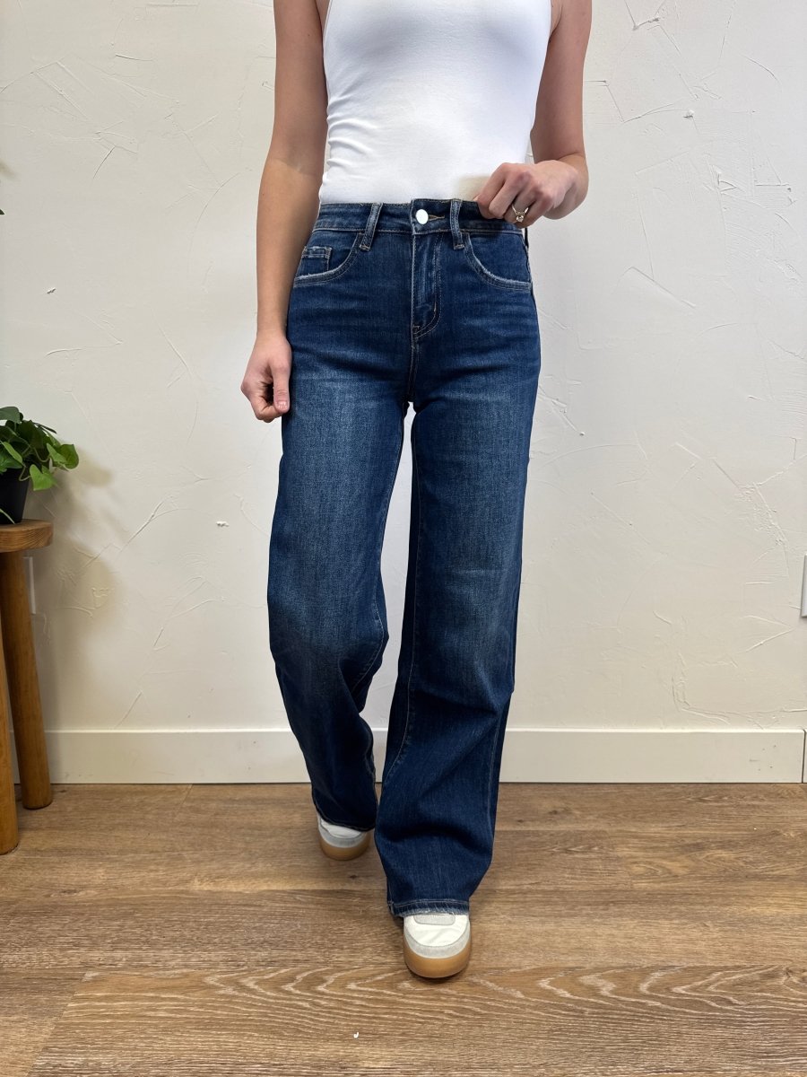 Front view of high rise dark wash wide leg jeans on model showing full length fit — Three:Twelve Boutique