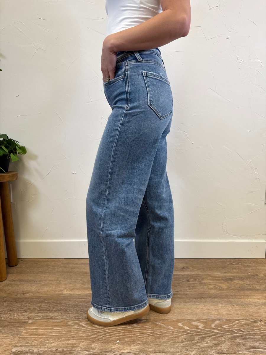 Side view of model wearing full length wide leg jeans showing relaxed silhouette — Three:Twelve Boutique