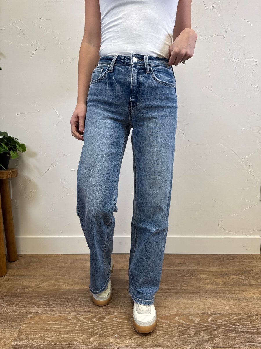 Front view of model wearing high rise medium wash wide leg jeans showing full length fit — Three:Twelve Boutique