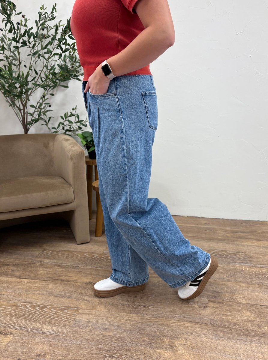 Side view of model wearing wide leg jeans showing flowy leg shape — Three:Twelve Boutique