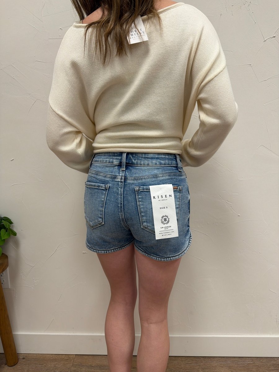 Back view of denim shorts highlighting pocket detail and structured fit — Three:Twelve Boutique