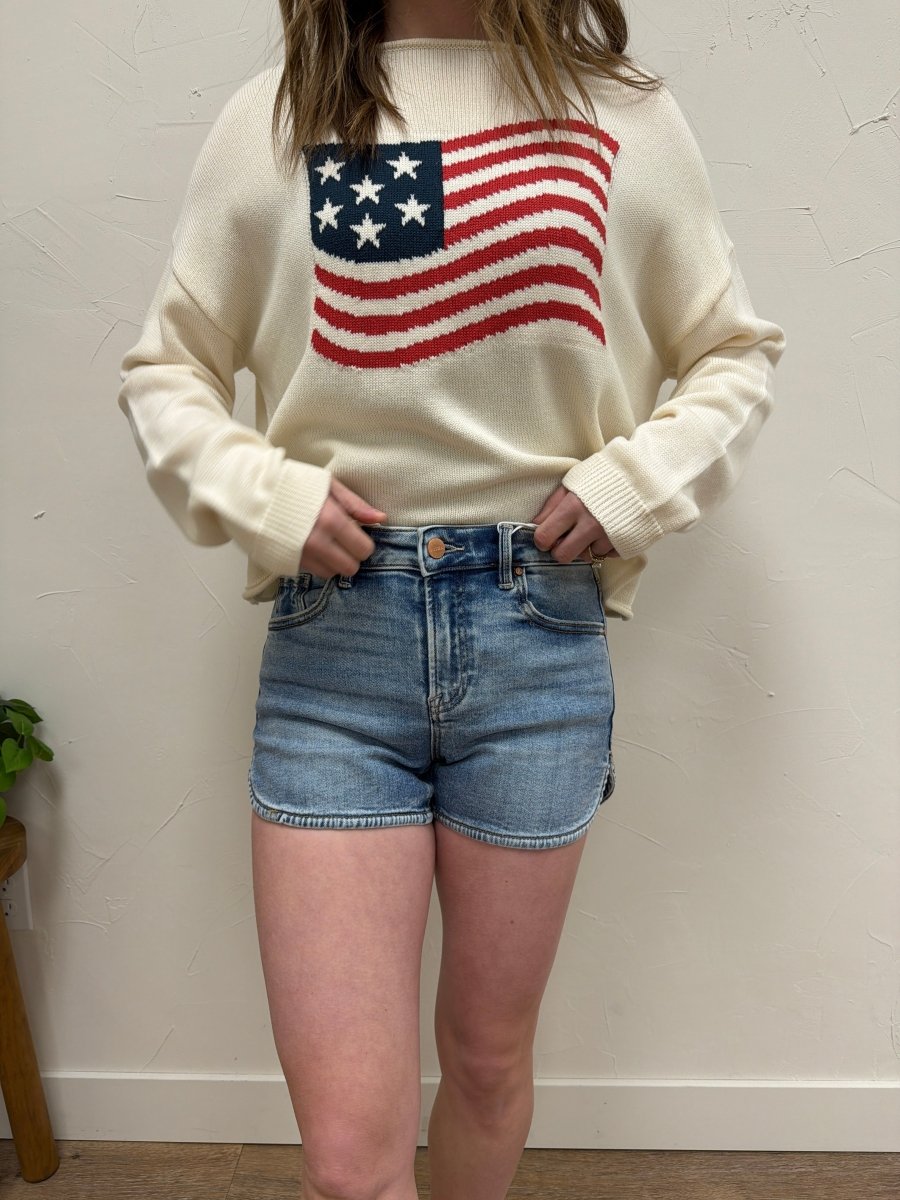 Lifestyle shot of model wearing high rise denim shorts styled casually — Three:Twelve Boutique