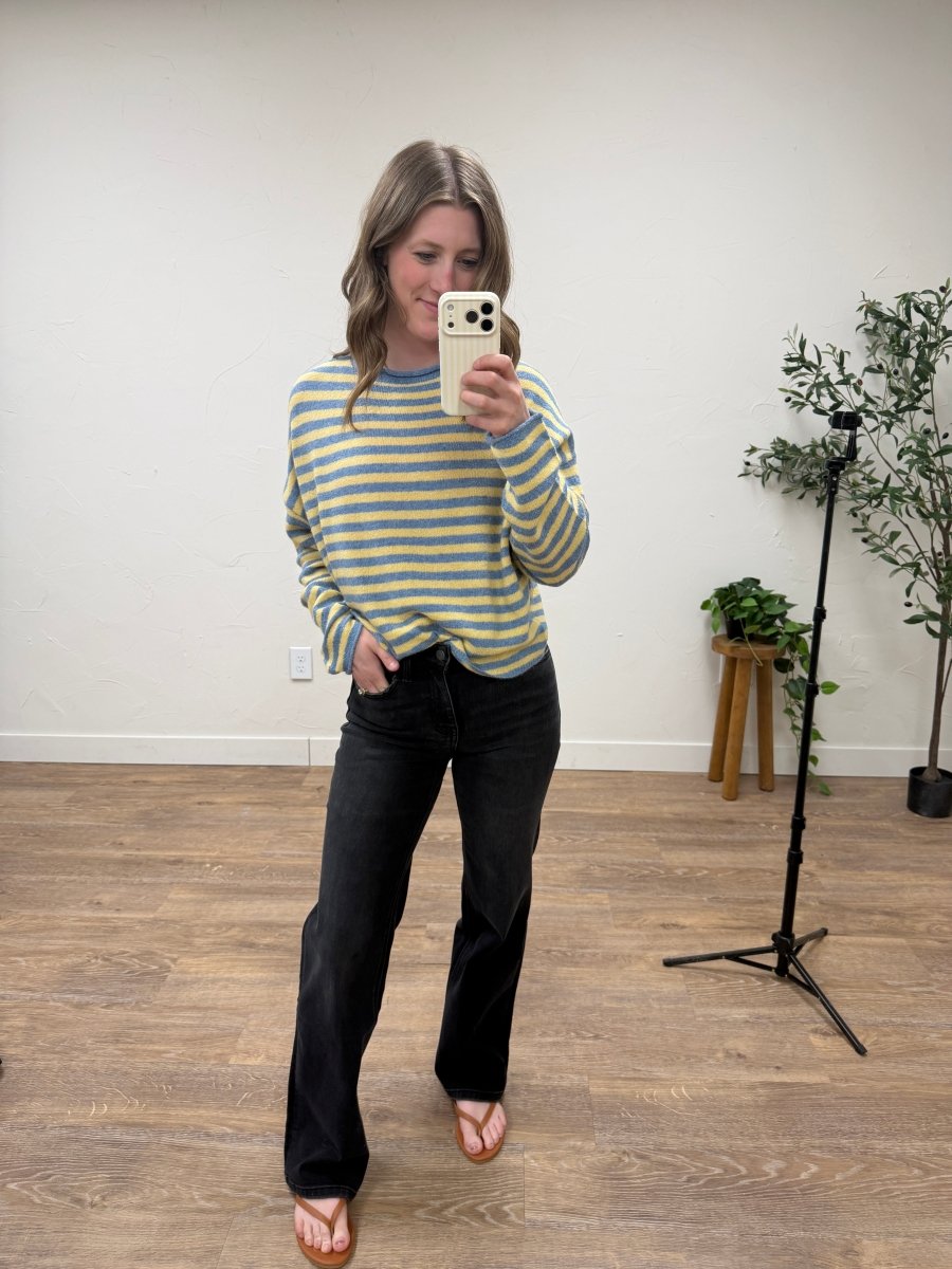 Lifestyle shot of model styling high rise denim jeans with casual outfit — Three:Twelve Boutique