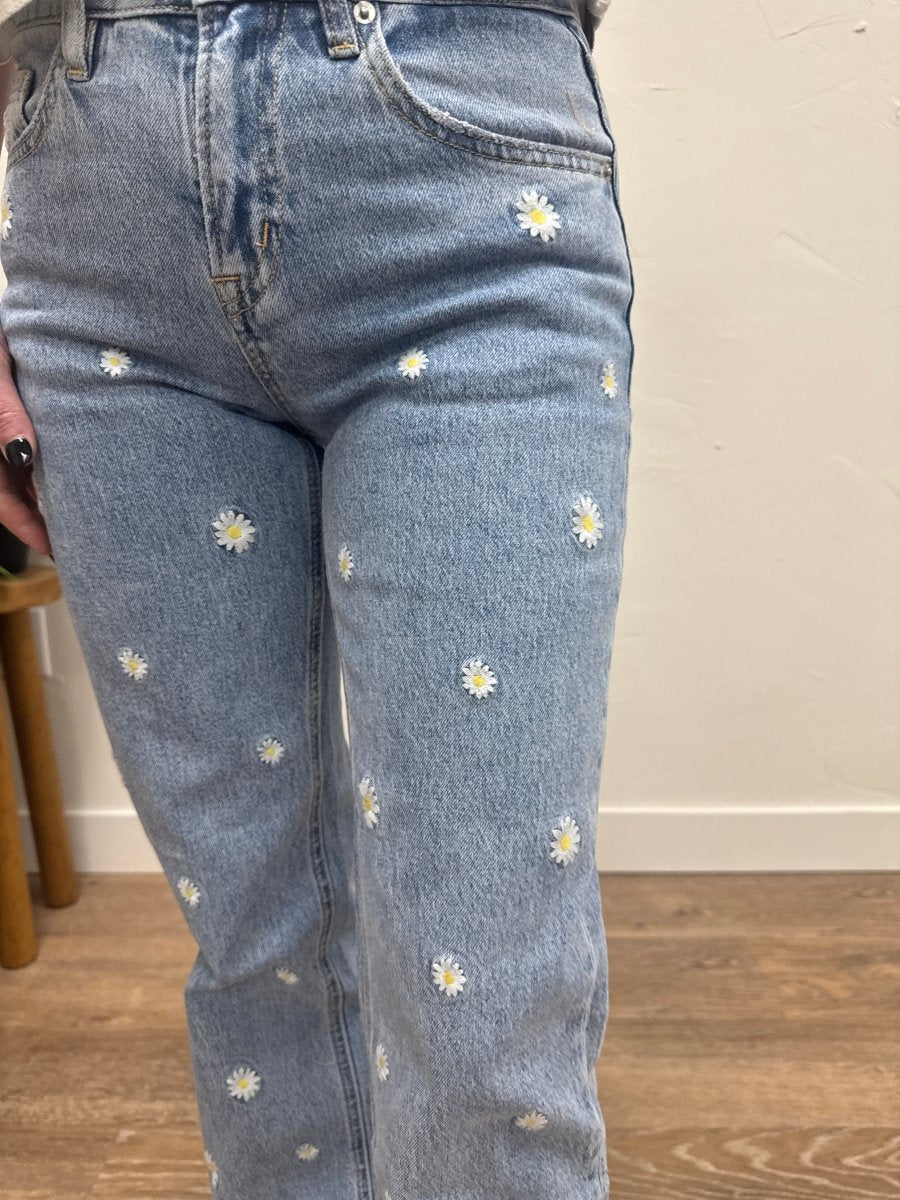 Close up of embroidery detail and denim texture on jeans — Three:Twelve Boutique
