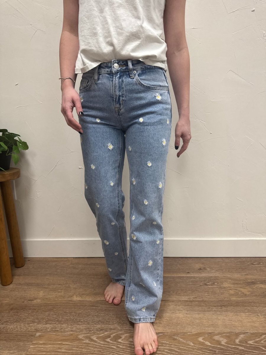 Lifestyle shot of model wearing straight leg jeans styled with casual top — Three:Twelve Boutique