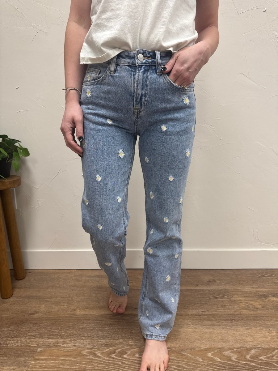 Lifestyle shot of model wearing straight leg jeans styled with casual top — Three:Twelve Boutique