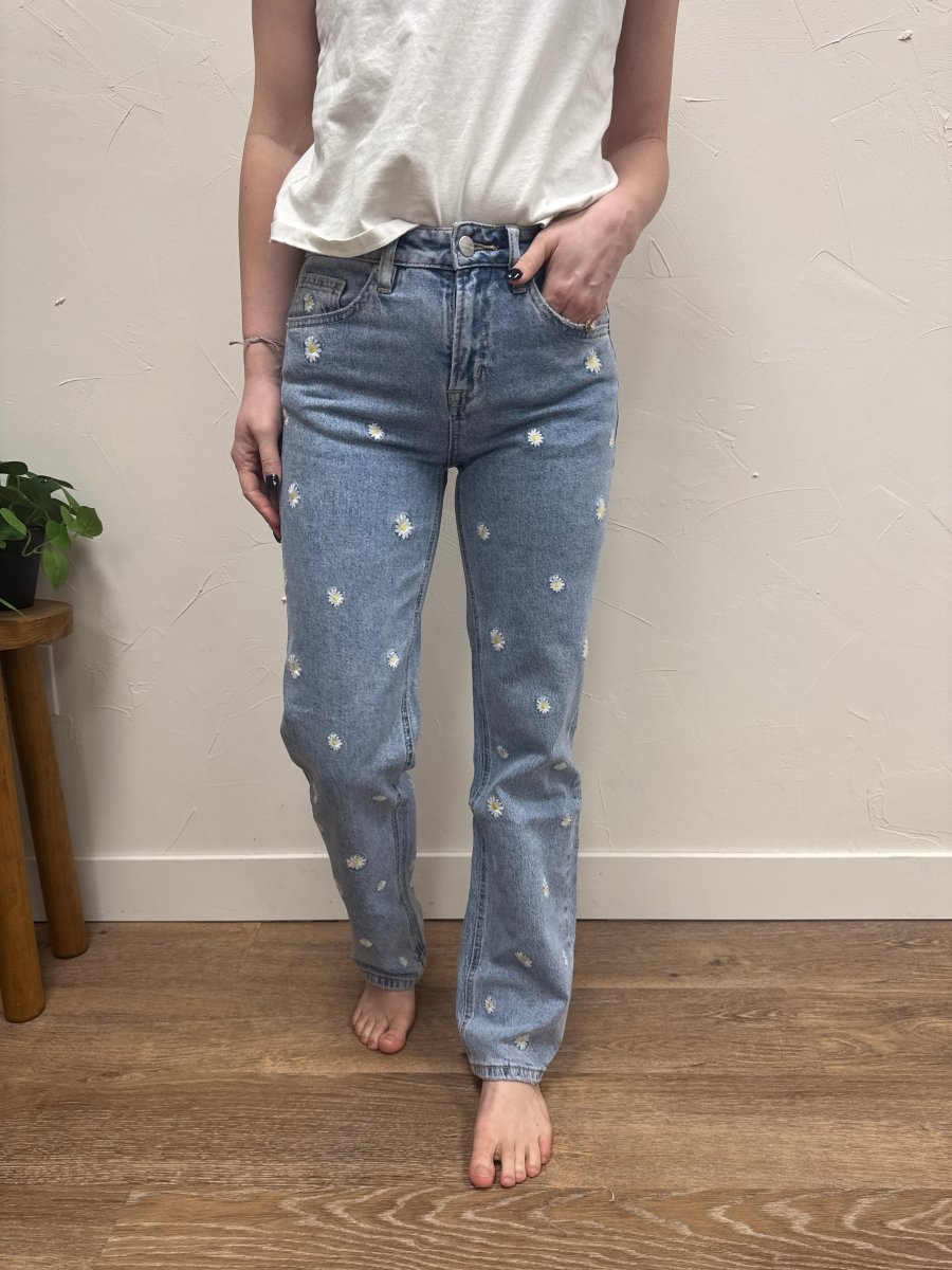 Lifestyle shot of model wearing straight leg jeans styled with casual top — Three:Twelve Boutique