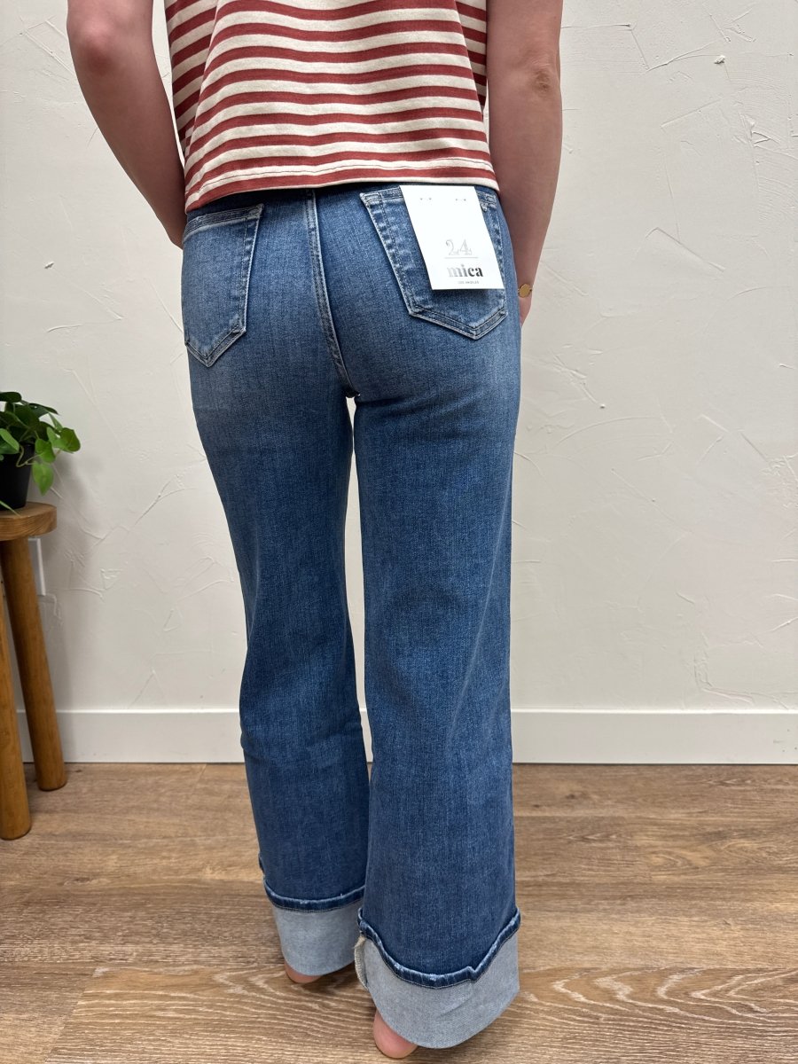 Back view of model wearing high rise jeans highlighting rear fit and structure — Three:Twelve Boutique