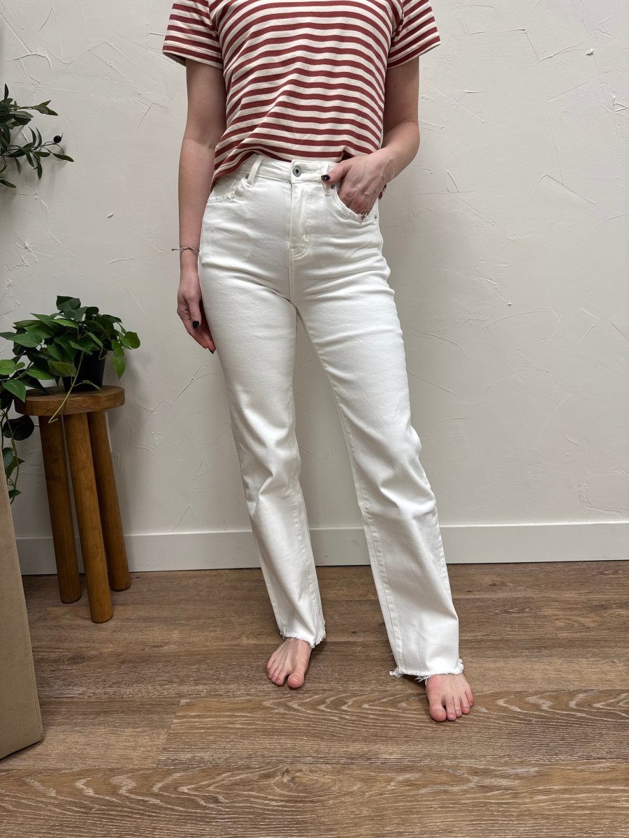 Lifestyle shot of model styling wide leg jeans with casual top — Three:Twelve Boutique
