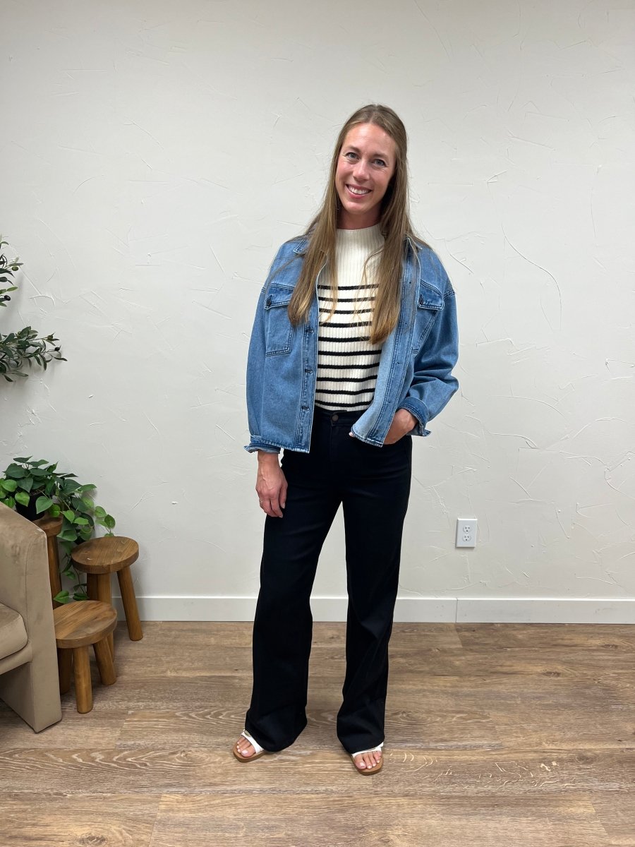 Lifestyle shot of model wearing wide leg jeans styled with casual top — Three:Twelve Boutique
