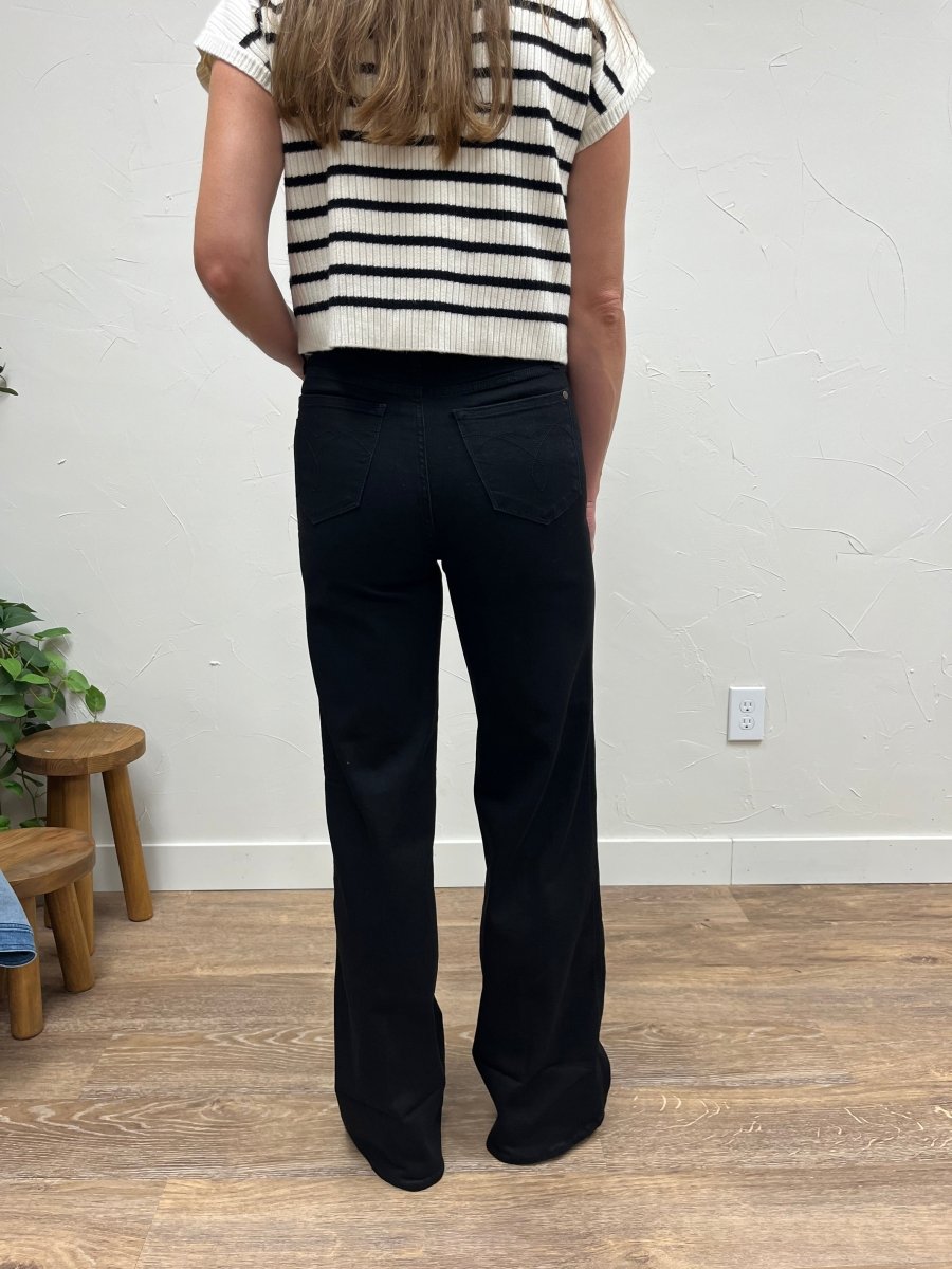 Back view of model wearing wide leg cuffed jeans showing fit and pocket detail — Three:Twelve Boutique