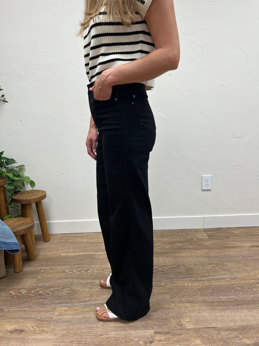 Side view of high waisted jeans showing wide leg silhouette and cuffed ankle — Three:Twelve Boutique