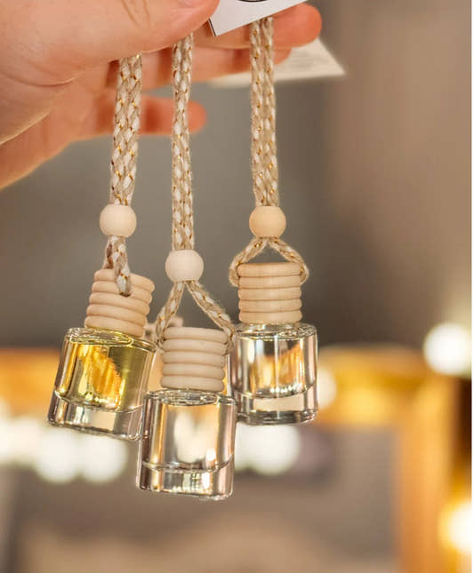 Front view of iced vanilla car diffuser with blue bottle and hanging cord — Three:Twelve Boutique