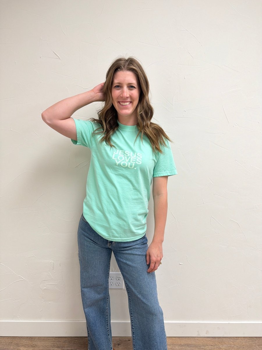 Lifestyle image of model wearing Jesus Loves Me Tee Green for casual fall styling — Three Boutique