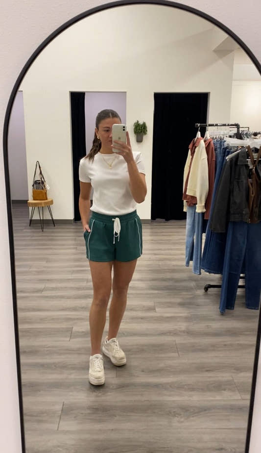 Lifestyle shot of model styling Kirsten shorts with casual top — Three:Twelve Boutique