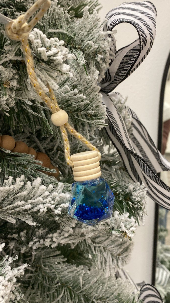 Front view of Lava car diffuser bottle with wooden cap and hanging cord — Three:Twelve Boutique