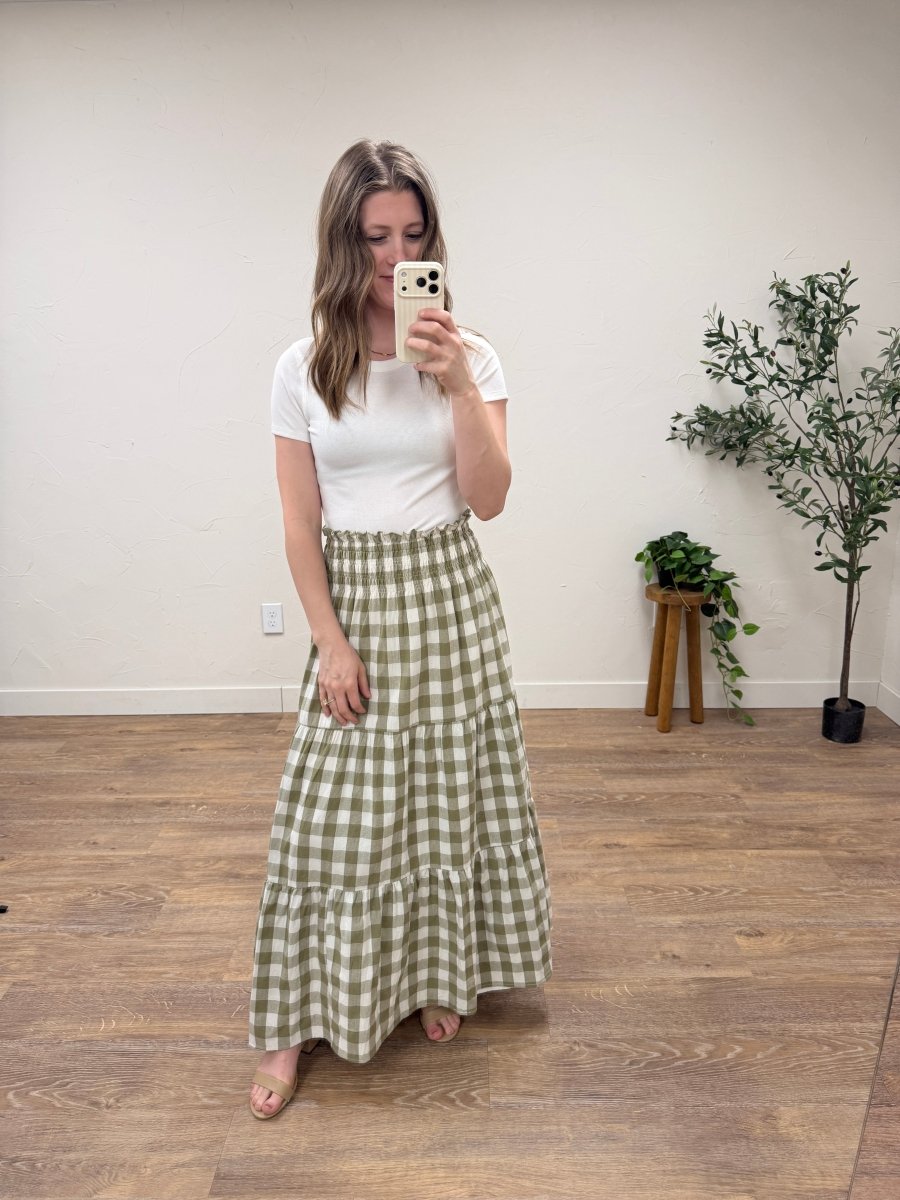 Lifestyle shot of model wearing willow check maxi skirt styled with casual outfit — Three:Twelve Boutique