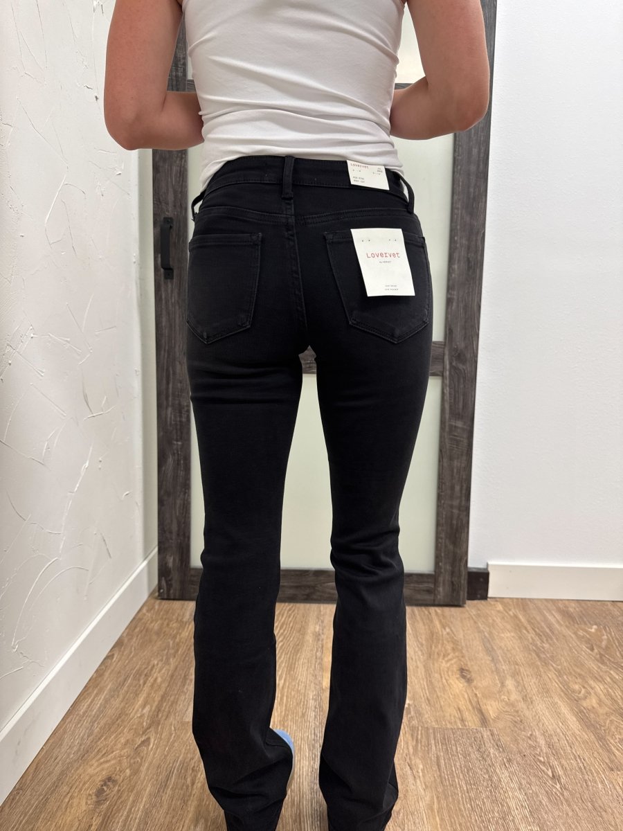Back view of model wearing bootcut denim jeans showing pocket and fit — Three:Twelve Boutique