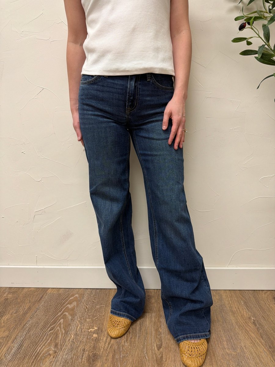 Lifestyle shot of model styling wide leg jeans with casual outfit — Three:Twelve Boutique