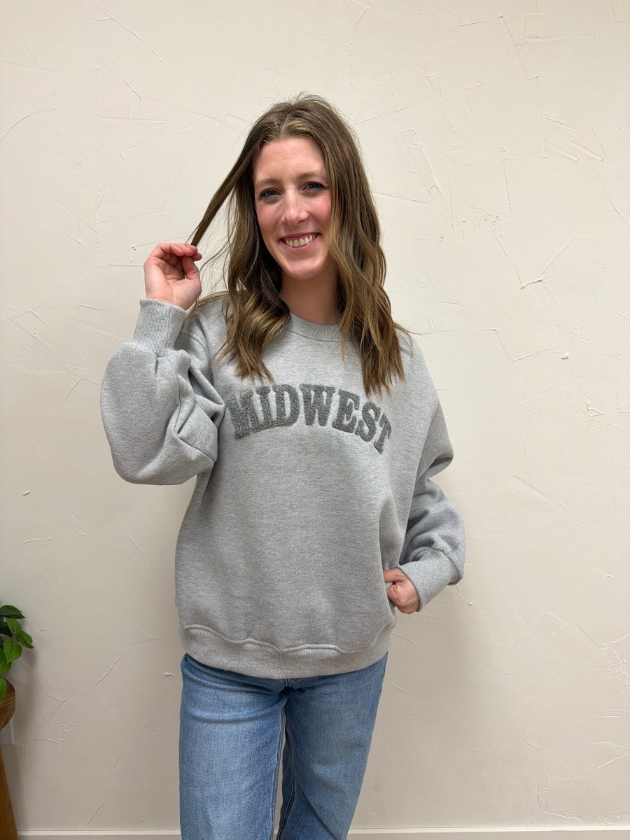 Lifestyle shot of model wearing Midwest Sweatshirt with casual denim pants — Three:Twelve Boutique