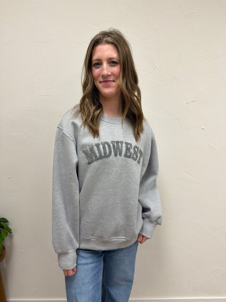 Lifestyle shot of model wearing Midwest Sweatshirt with casual denim pants — Three:Twelve Boutique