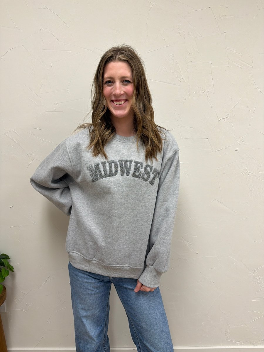 Lifestyle shot of model wearing Midwest Sweatshirt with casual denim pants — Three:Twelve Boutique