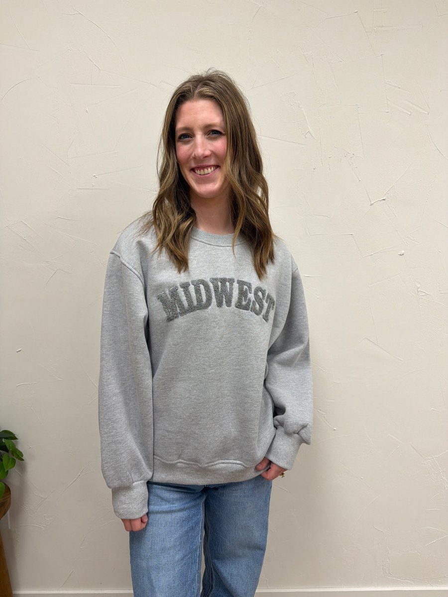 Lifestyle shot of model wearing Midwest Sweatshirt with casual denim pants — Three:Twelve Boutique