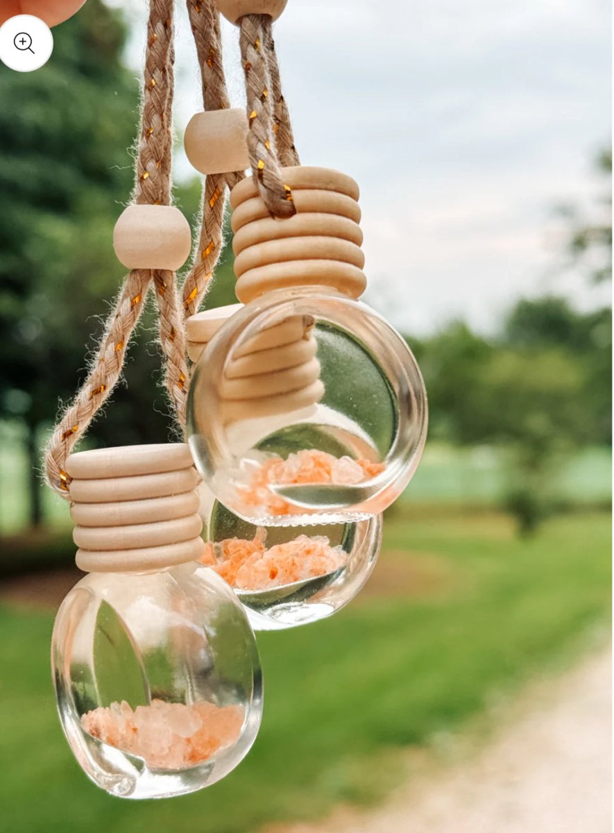 Hanging view of Pink Sands car diffuser in car interior from rearview mirror — Three:Twelve Boutique