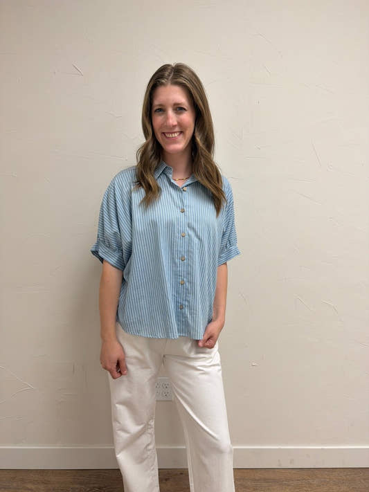Front view of model wearing Pinstripe Denim Button Down Top for Women with button-front design and pinstripe pattern