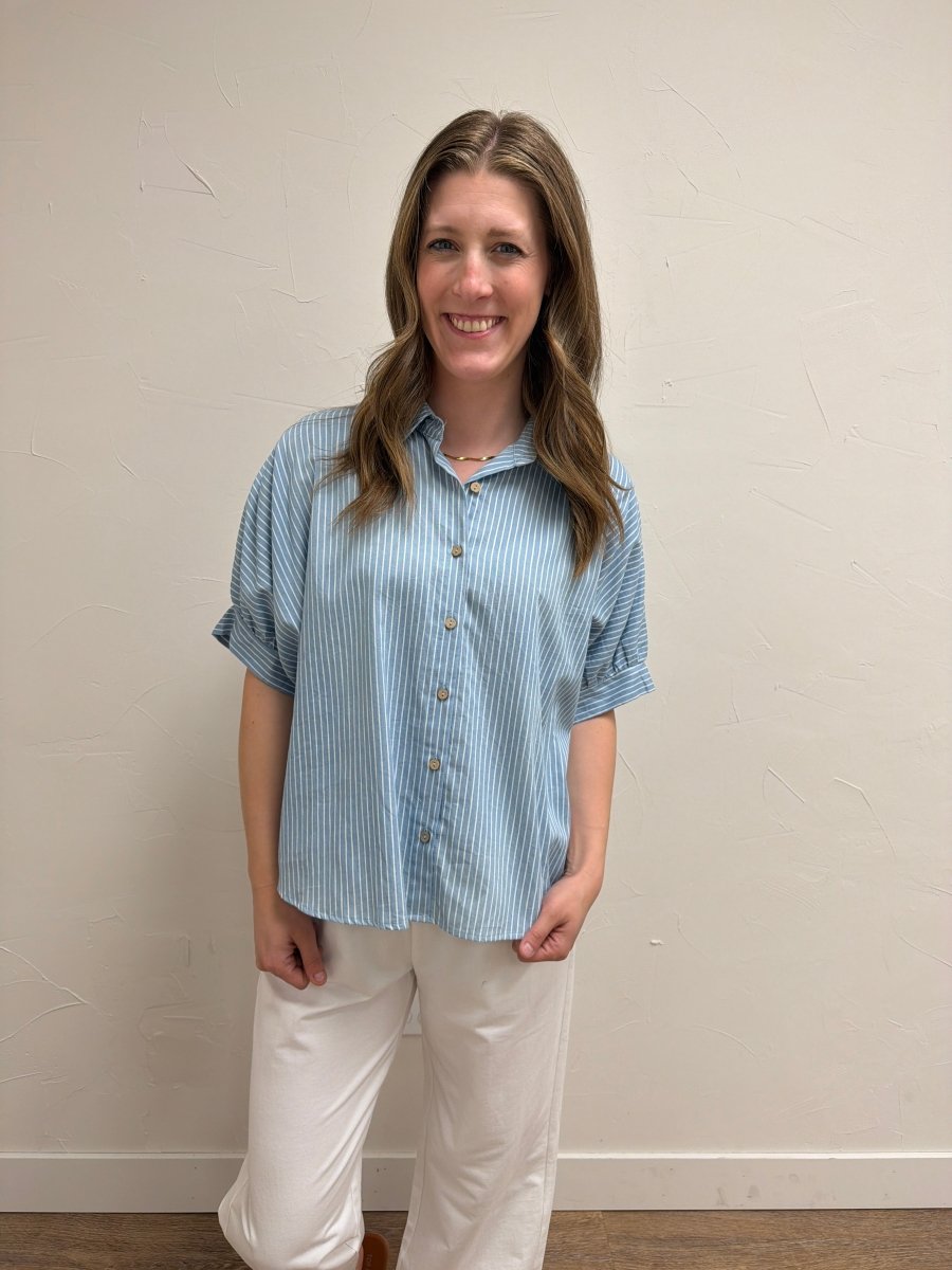 Front view of model wearing Pinstripe Denim Button Down Top for Women with button-front design and pinstripe pattern