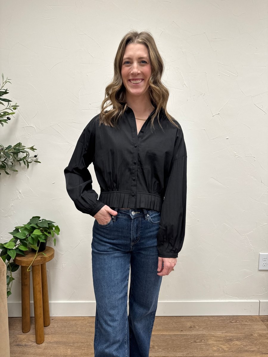 Lifestyle shot of model wearing raglan shirt styled casually with denim — Three:Twelve Boutique