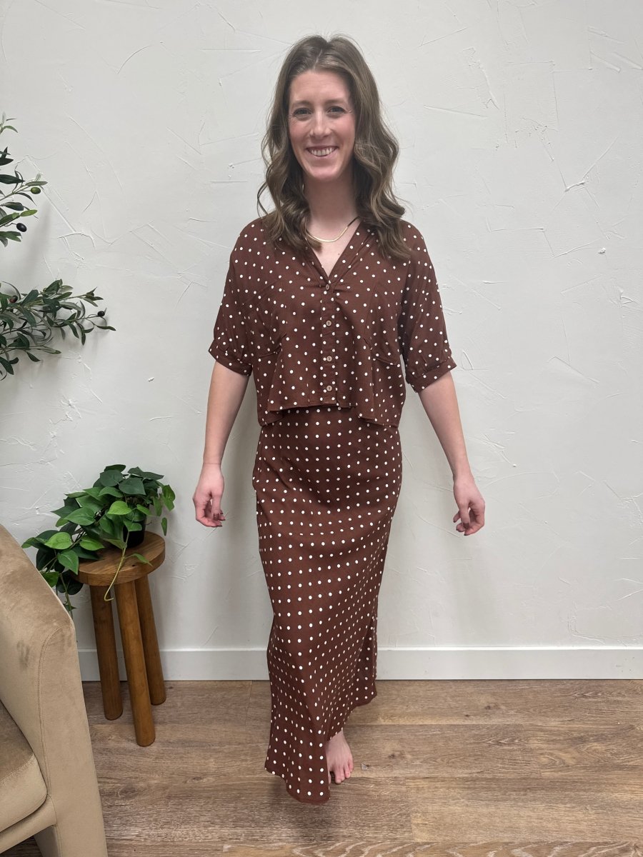 Lifestyle shot of model wearing polka dot skirt styled with top — Three:Twelve Boutique