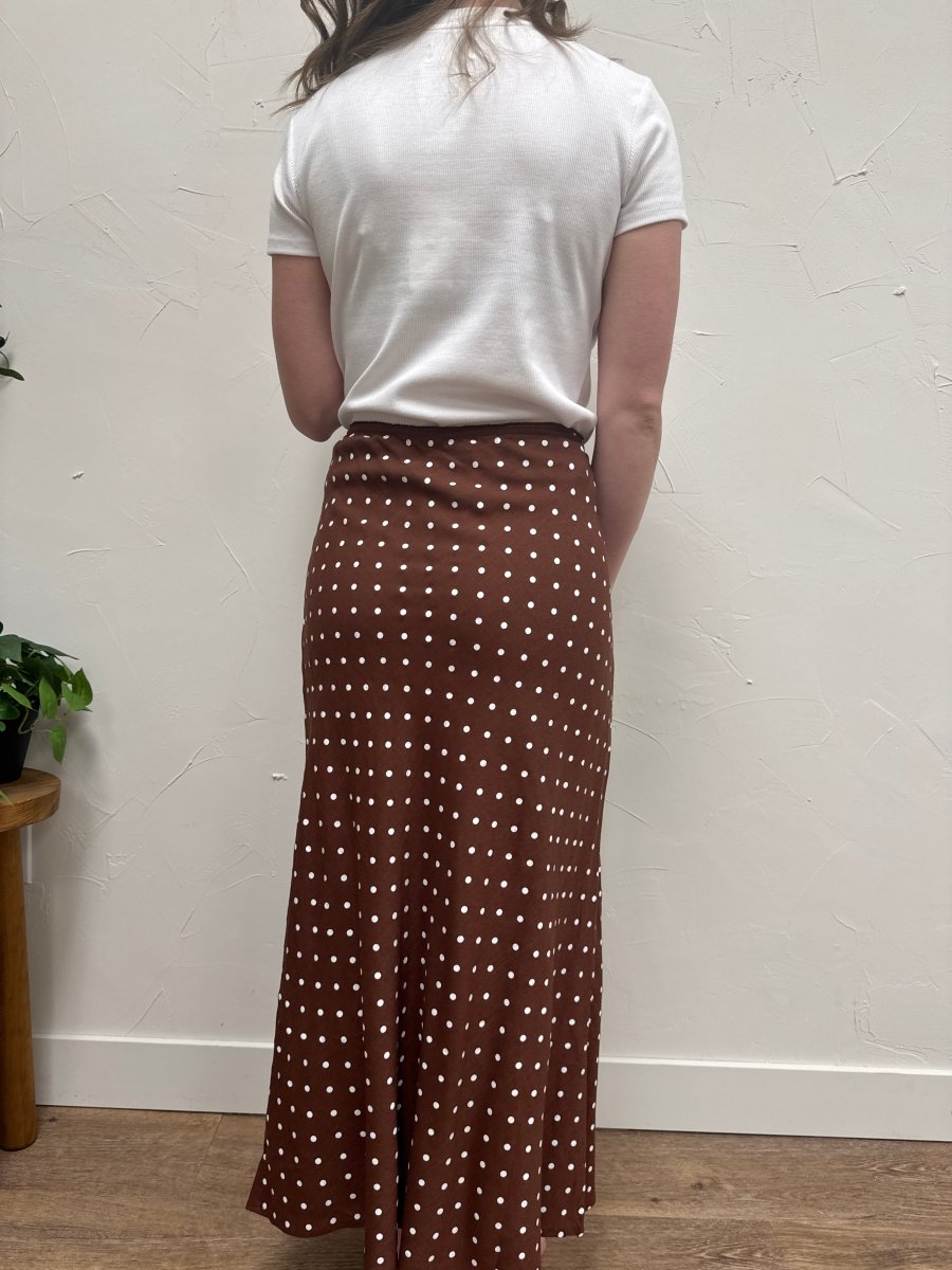 Back view of polka dot skirt on model highlighting waistband and fit — Three:Twelve Boutique