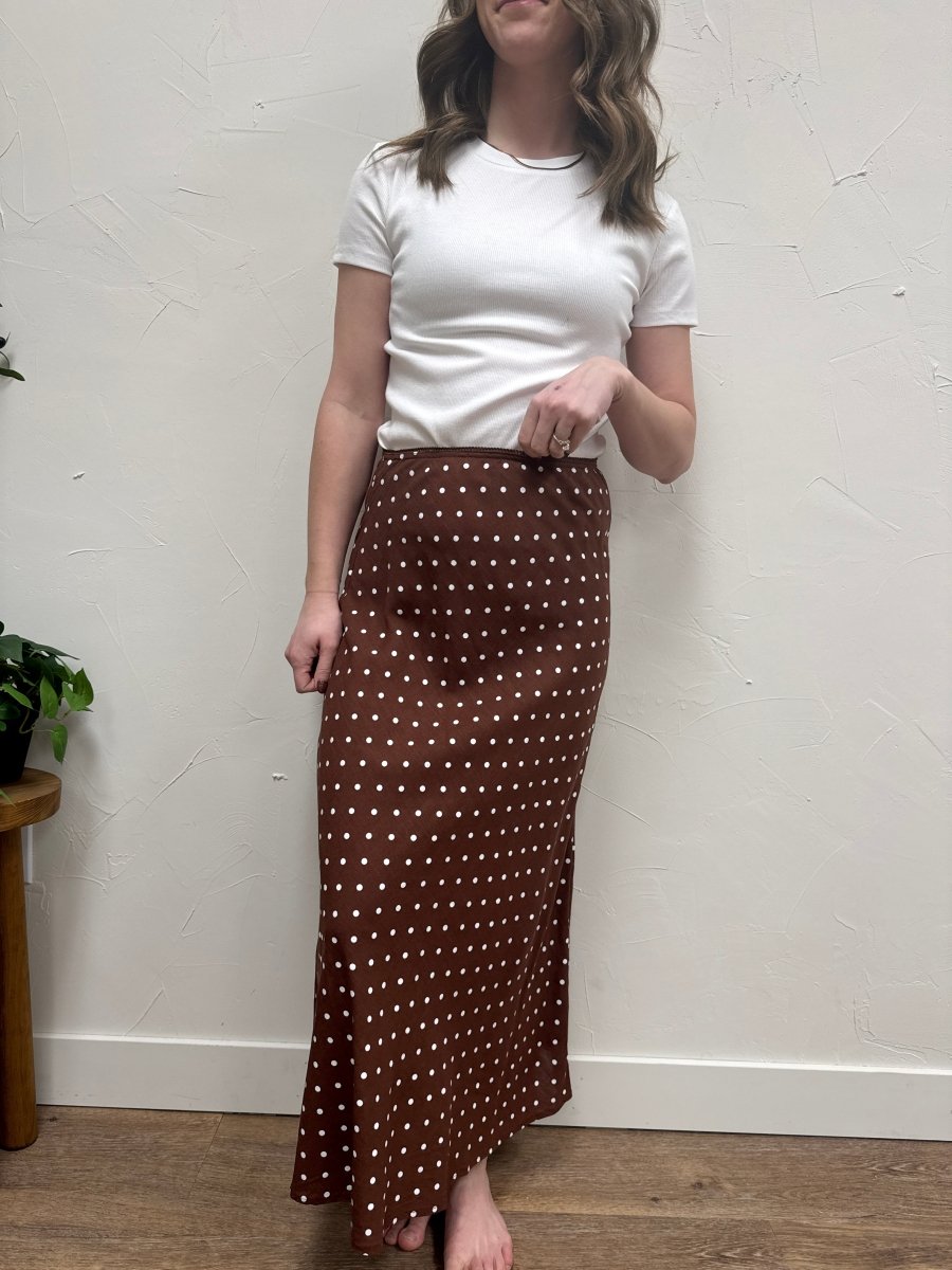 Front view of polka dot A-line skirt on model showing flowy silhouette — Three:Twelve Boutique