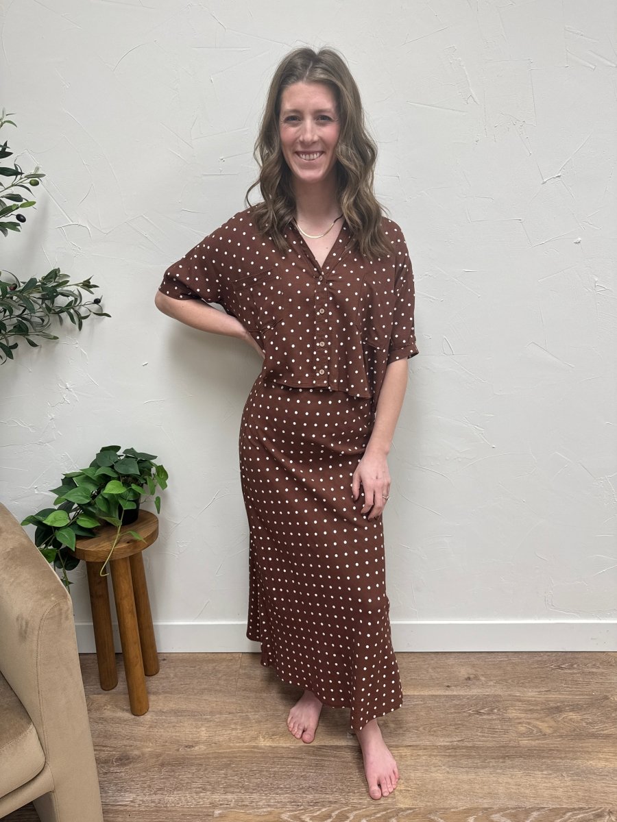 Lifestyle shot of model wearing polka dot skirt styled with top — Three:Twelve Boutique