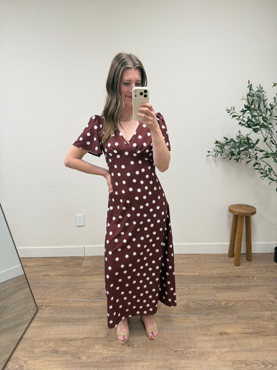 Lifestyle image of model wearing blue polka dot maxi dress for everyday styling — Three Boutique