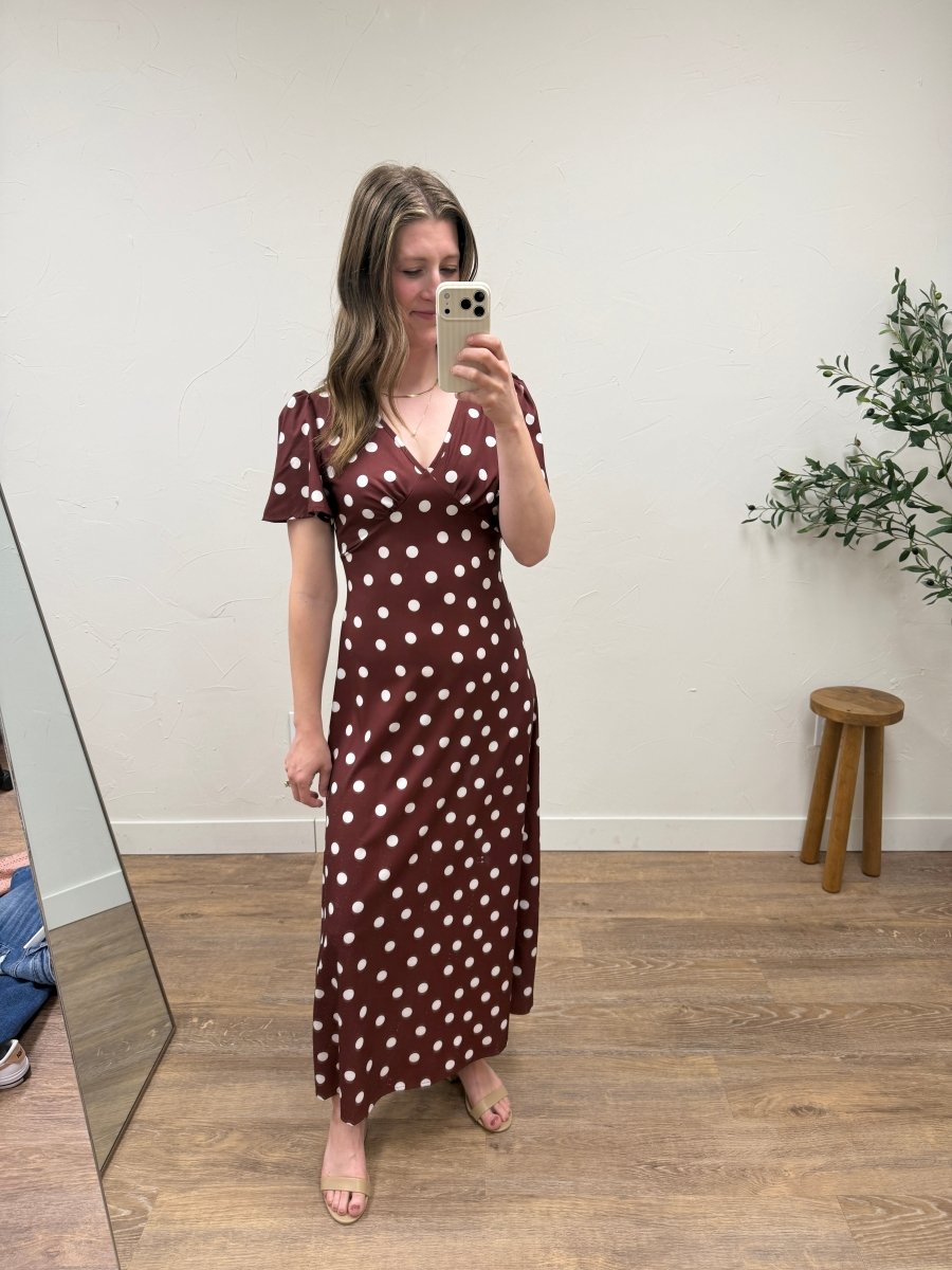 Lifestyle image of model wearing blue polka dot maxi dress for everyday styling — Three Boutique