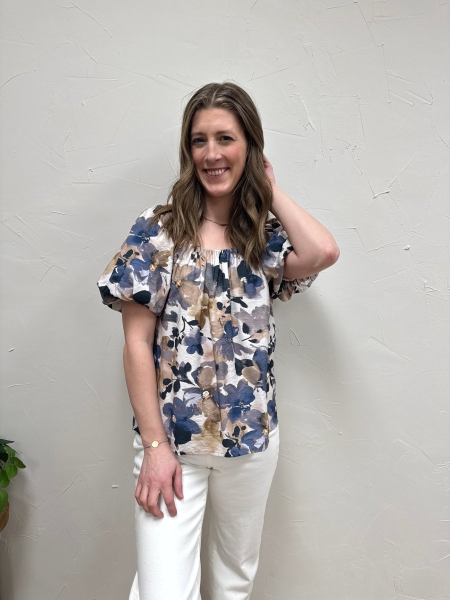 Lifestyle shot of model wearing puff sleeve top styled with casual denim — Three:Twelve Boutique