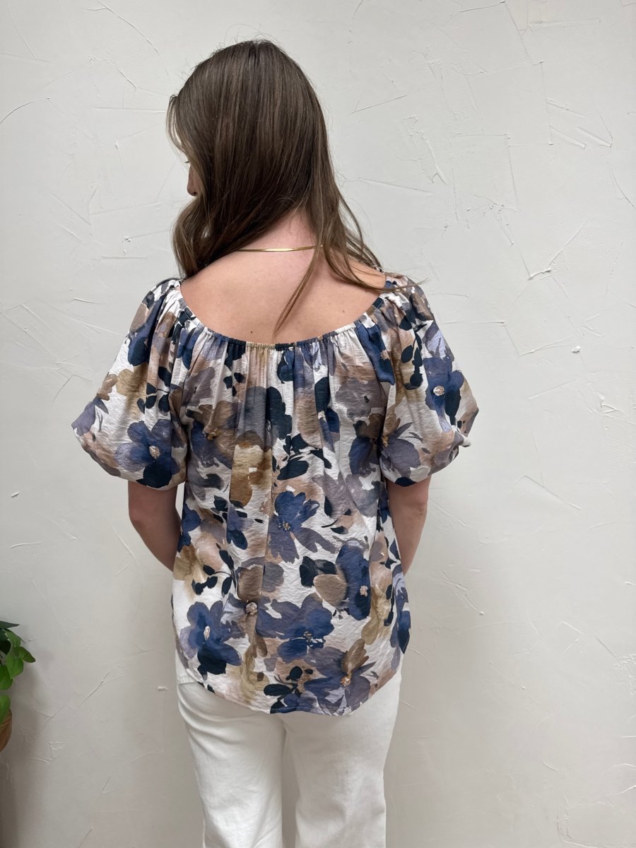 Back view of puff sleeve woven top on model showing relaxed fit silhouette — Three:Twelve Boutique