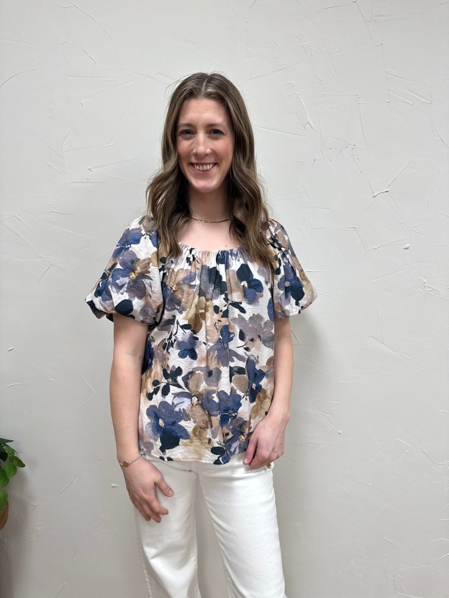 Lifestyle shot of model wearing puff sleeve top styled with casual denim — Three:Twelve Boutique