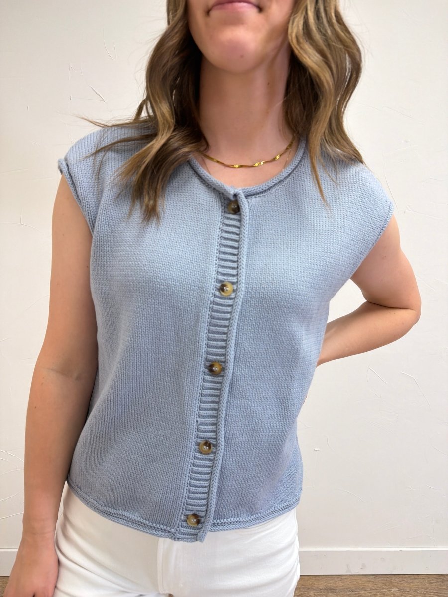 Close-up front view of model wearing Raw Edge Sleeveless Button Down Knit Cardigan showcasing raw edge detailing and button-front design