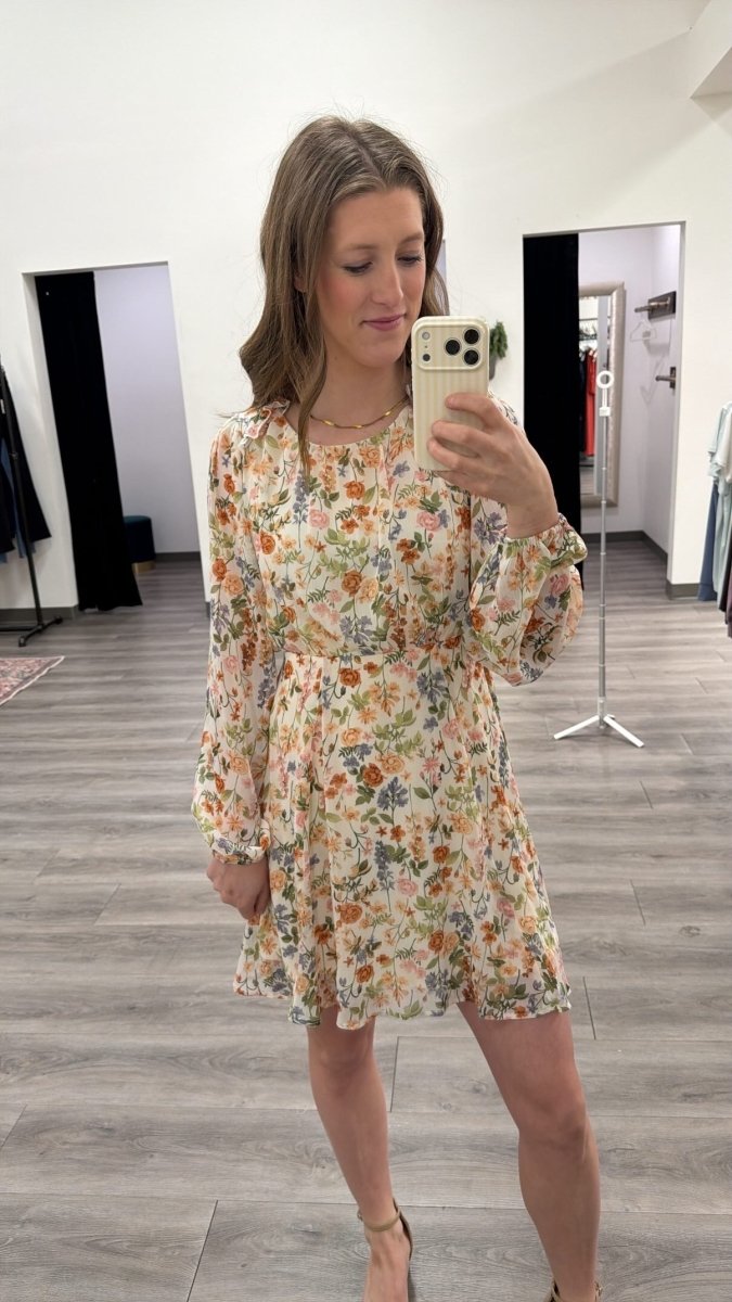 Front view of model wearing floral print long sleeve mini dress with round neckline — Three:Twelve Boutique